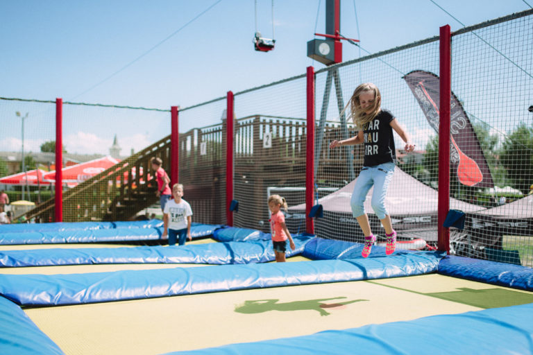 Children jumping on trampoline in amusement park Podersdorf am See